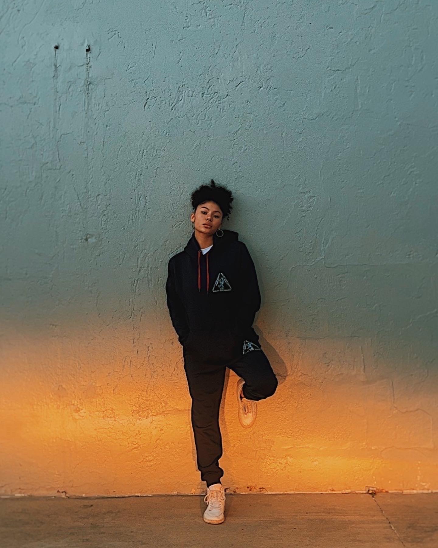 Full-length model shot in PETRO QOQ set against sunset-lit wall